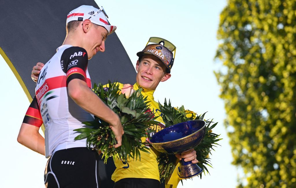 JumboVisma teams Danish rider Jonas Vingegaard R celebrates on the podium with the overall leaders yellow jersey next to UAE Team Emirates teams Slovenian rider Tadej Pogacar L placing overall second after the 109th edition of the Tour de France cycling race after the 21st and final 1156 km stage between La Defense Arena in Nanterre outside Paris and the ChampsElysees in Paris France on July 24 2022 Photo by Marco BERTORELLO AFP Photo by MARCO BERTORELLOAFP via Getty Images