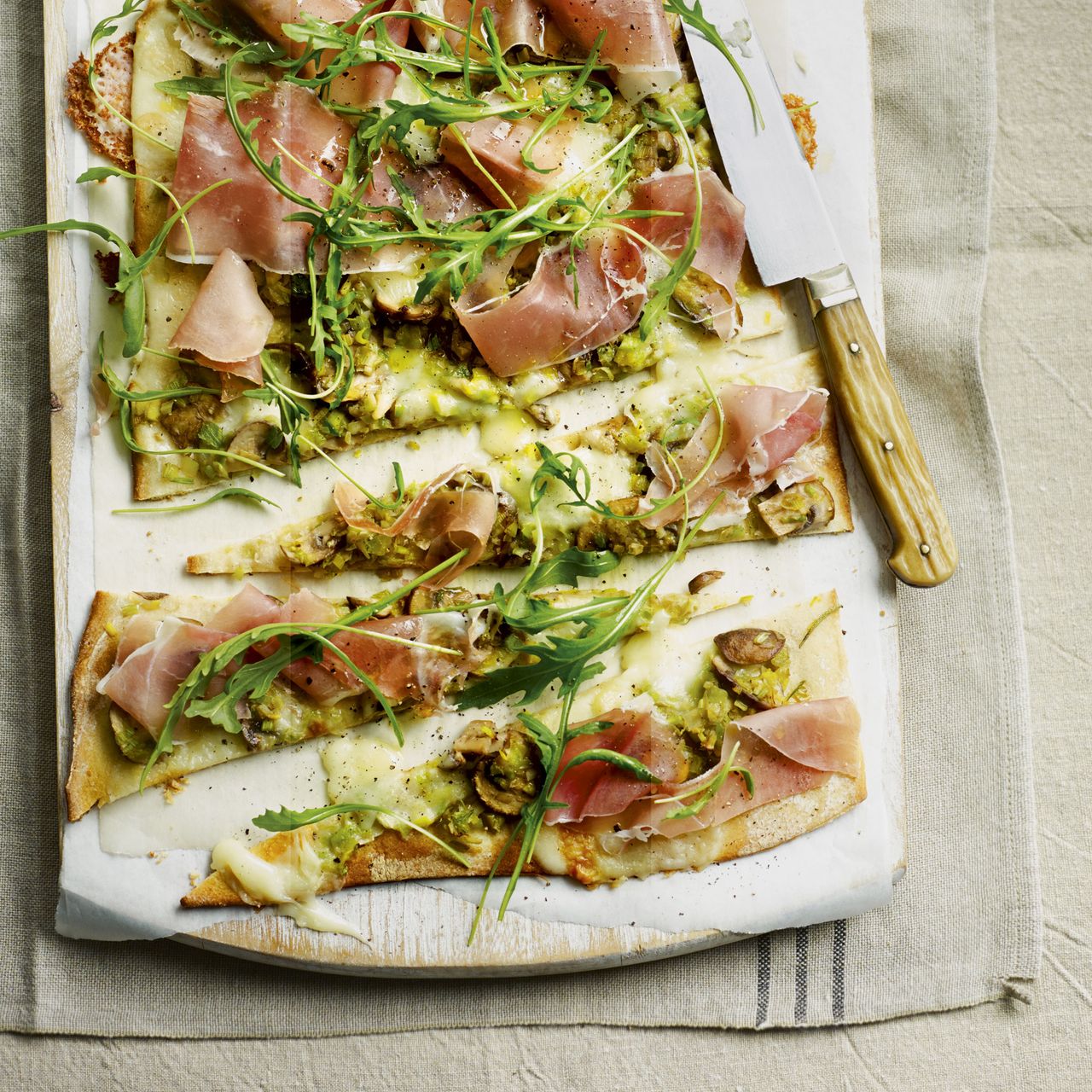 leek mushroom and taleggio pizza with sliced prosciutto