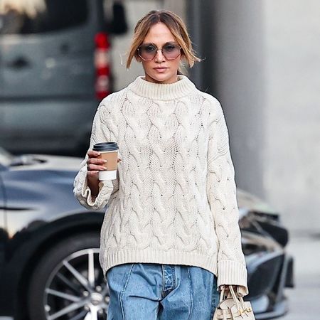 Jennifer Lopez wears a cable knit jumper and Uggs.