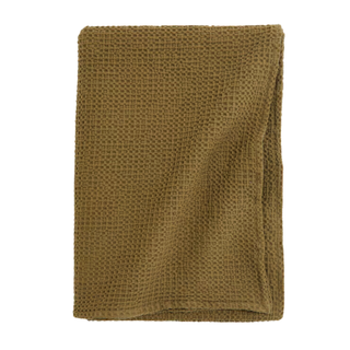 An olive green waffle throw blanket