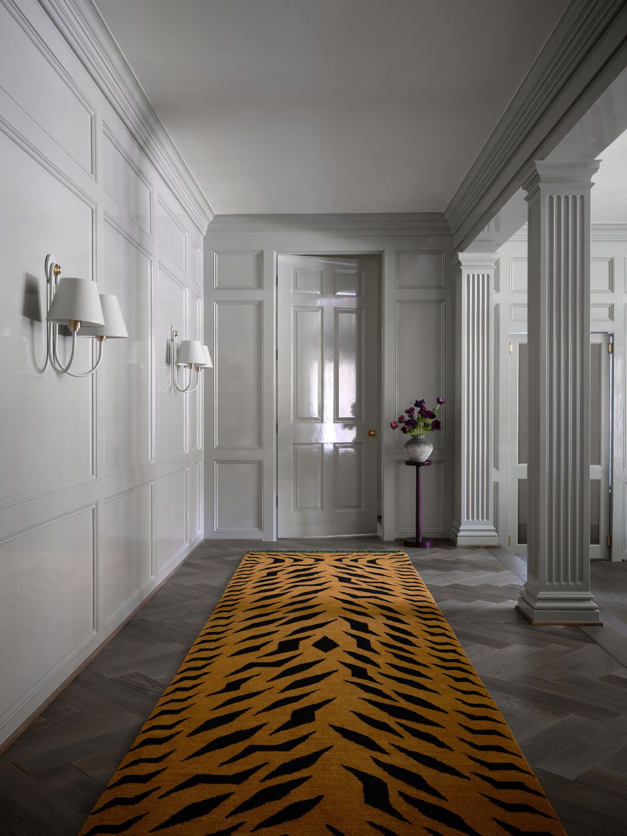 a white hallway with a tiger print runner rug
