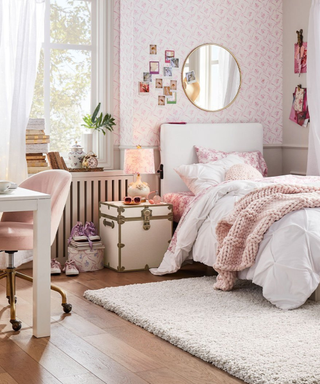 pink room from pottery barn dorm with a white trunk as a nightstand
