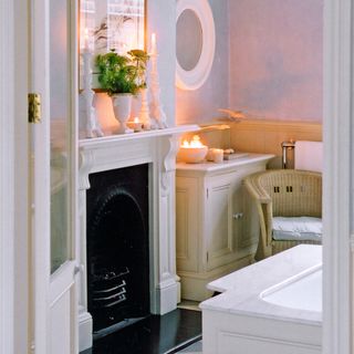bathroom with fireplace and cream cabinet