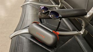 Viture One XR glasses on an airport seat