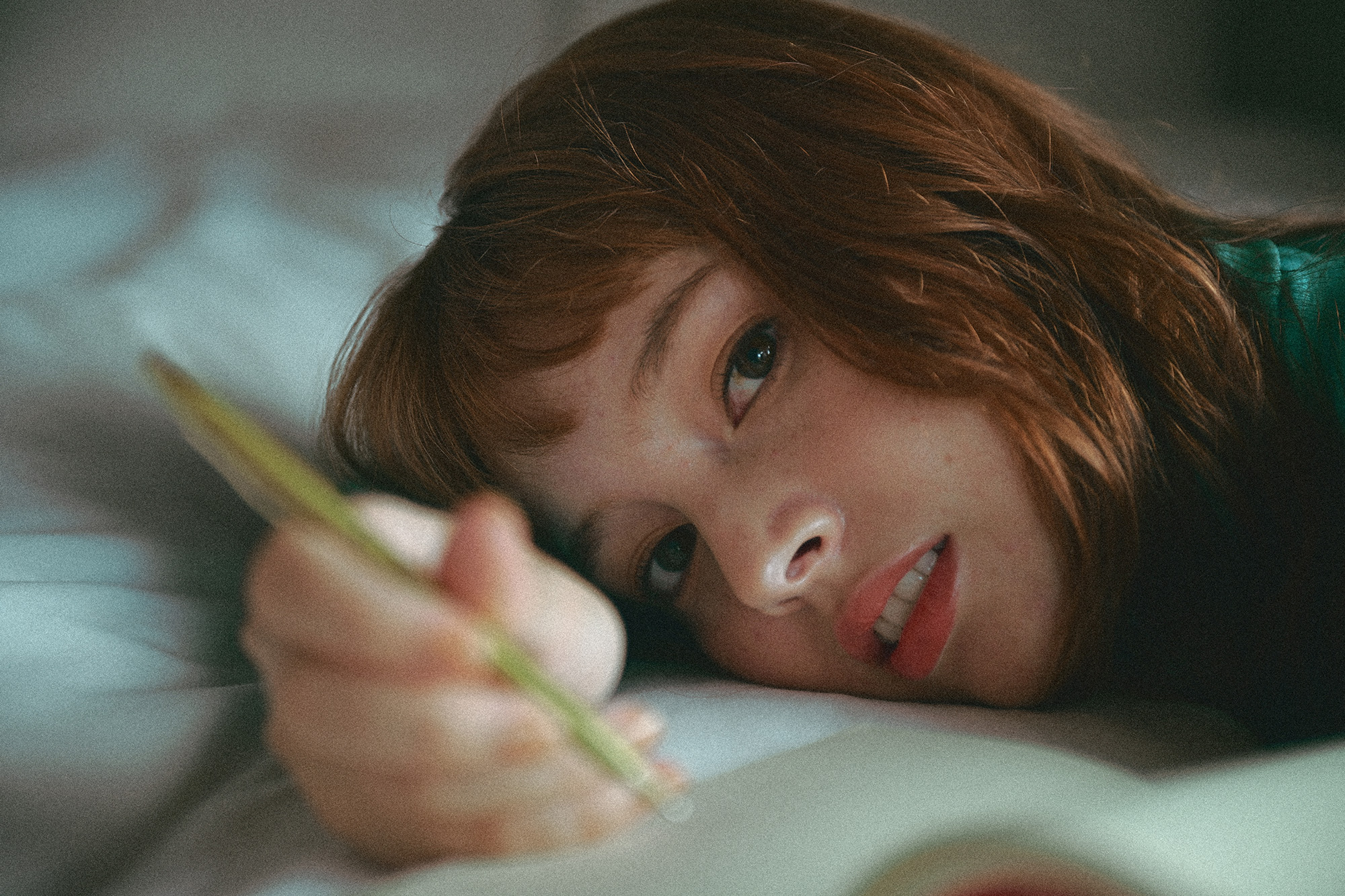 Nikon Zf Film Grain image, showing a person lying on a bed looking into camera