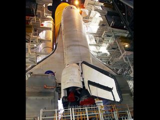 Work platforms inside the Vehicle Assembly Building at NASA's Kennedy Space Center in Florida surround the space shuttle Discovery, its solid rocket boosters and external fuel tank.