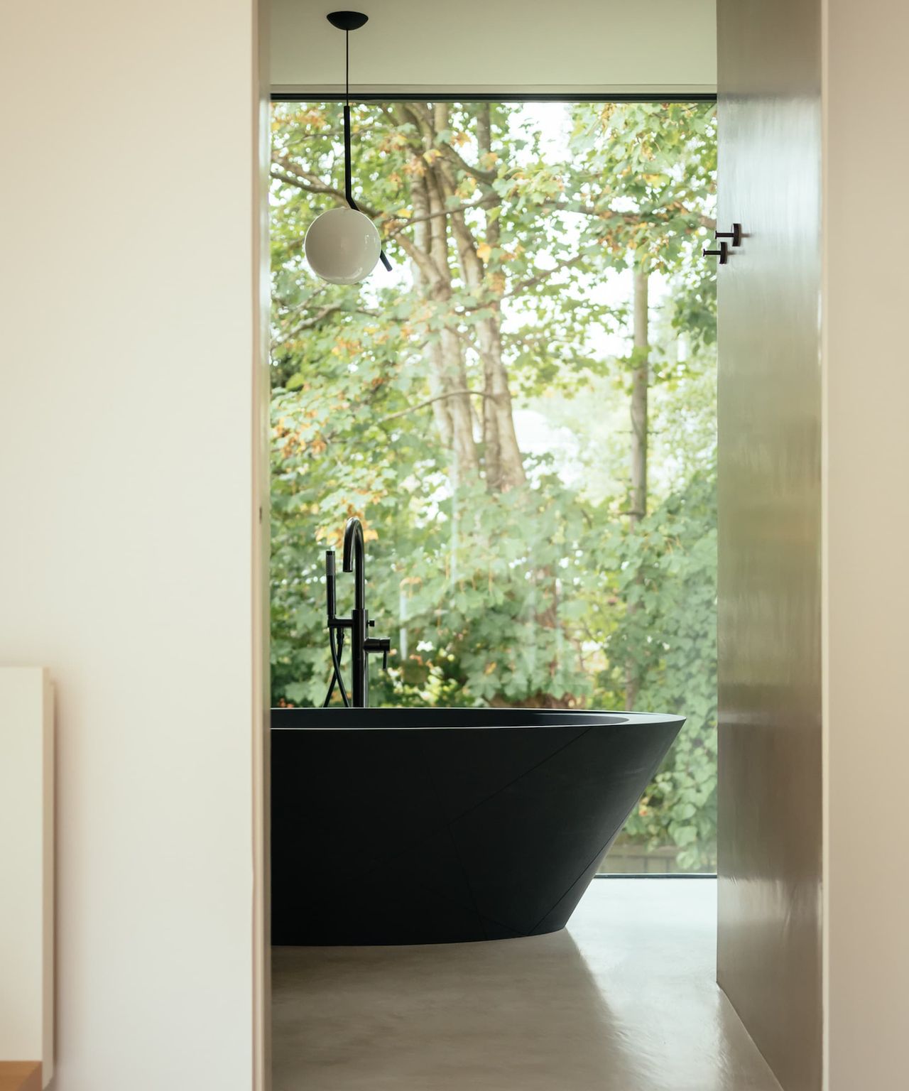 A black bath in an en suite bathroom
