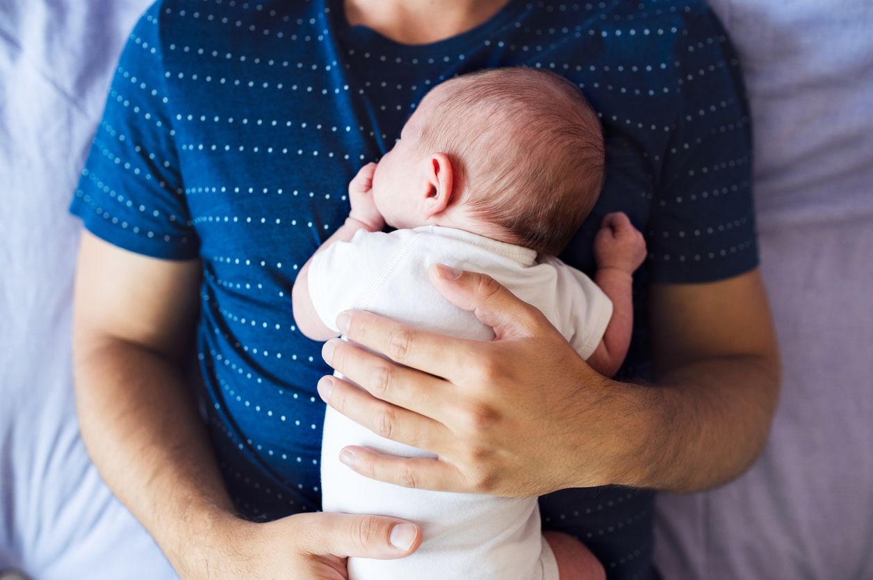 A father holds his baby.