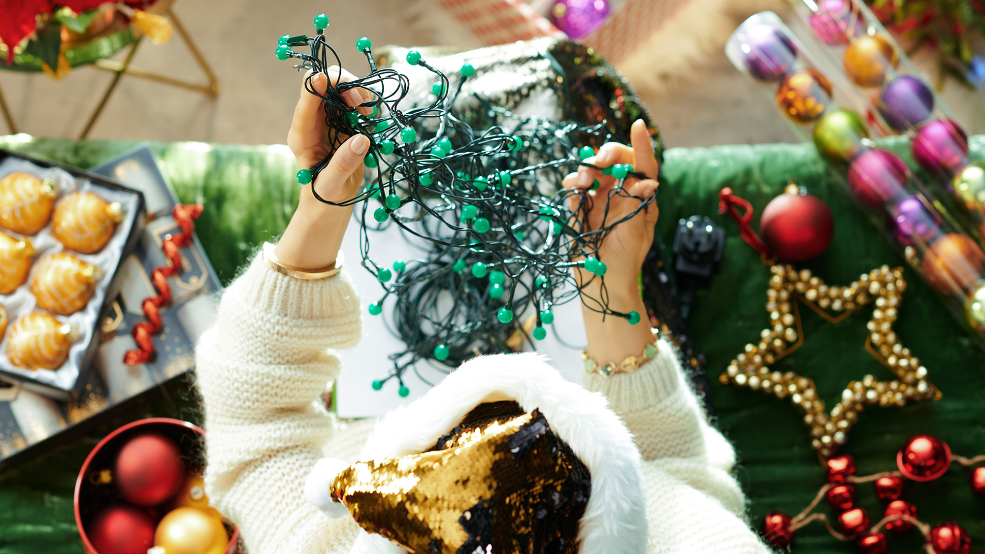 Woman untangling Christmas lights