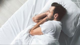 man laying on white pillow