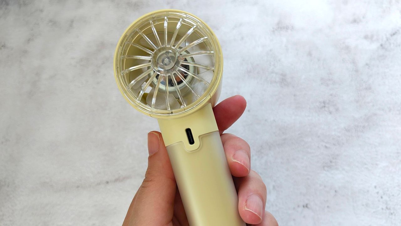 John Lewis fan in reviewer's hand showing USB socket