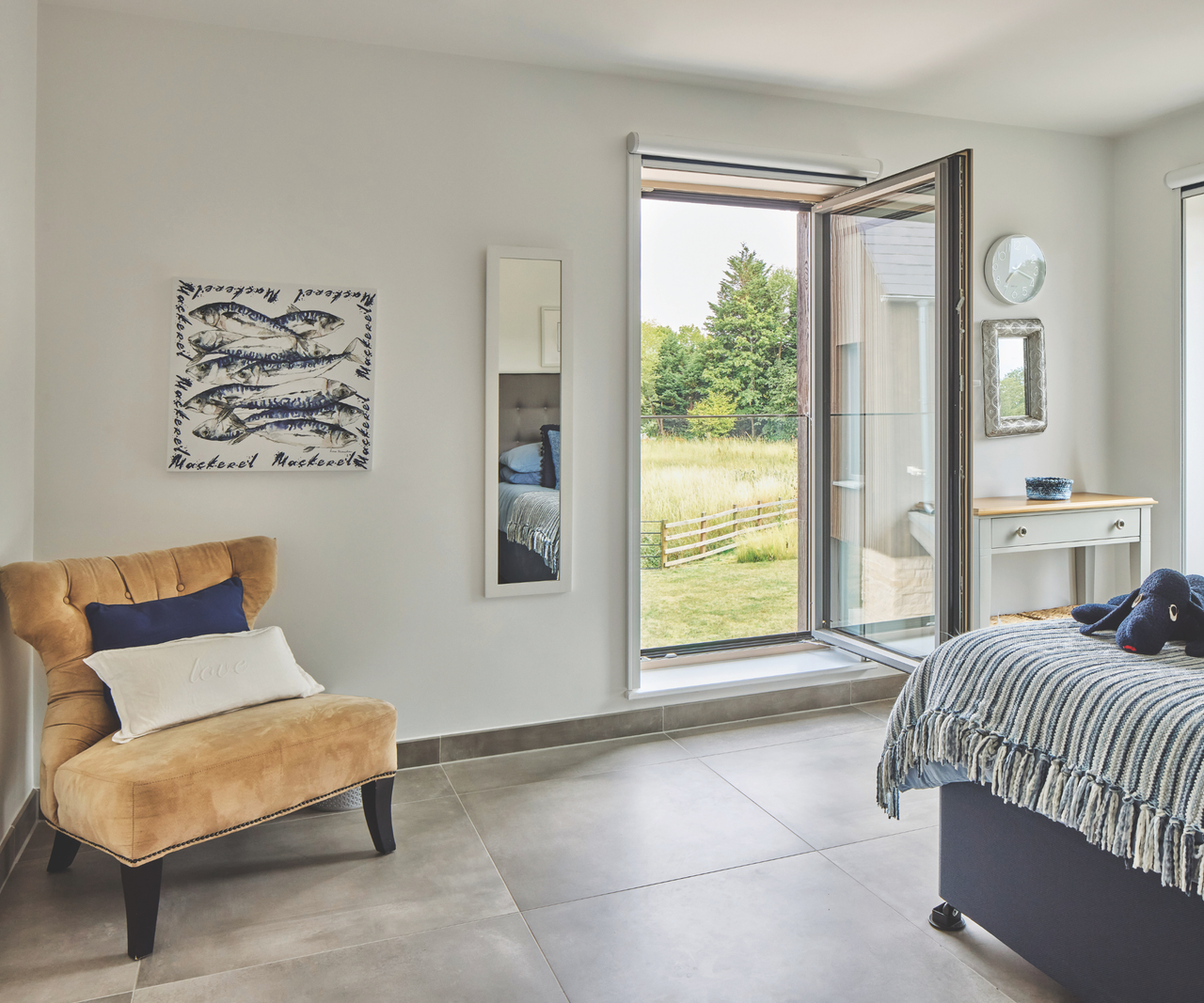 Bedroom with large window open, overlooking garden