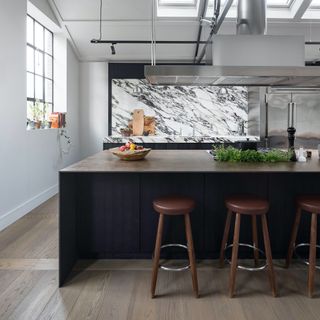Modern kitchen with large island unit and marble splashback