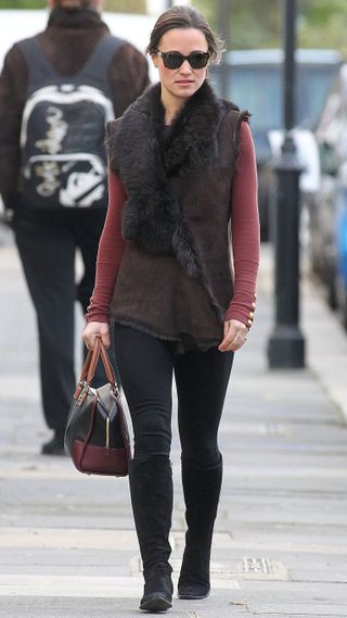 Pippa Middleton walks in London on January 06, 2012 wearing knee high boots and a gilet