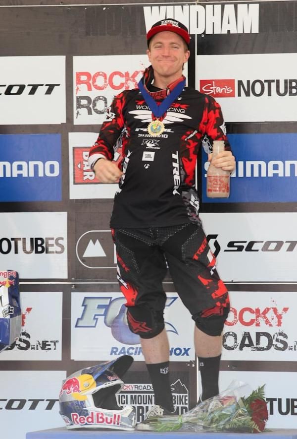 Aaron Gwin (Trek World Racing) in response to the crowds' cheers, the victor takes a drink of Battenkill Dairy chocolate milk.