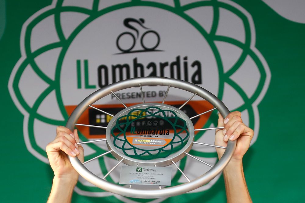 Thibaut Pinot holds the Il Lombardia trophy aloft
