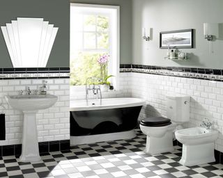 White and black bathroom ideas: Black bath with monochrome flooring and Art Deco mirror by Original Style
