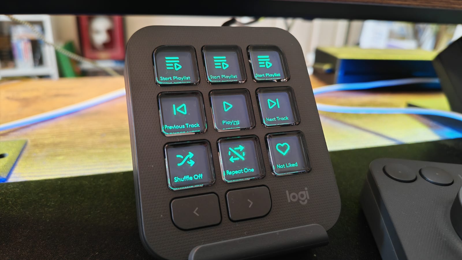 The MX Creative Console's keypad displaying Spotify functions