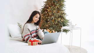 Woman using a laptop at Christmas