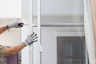 Construction worker repairing the sliding window