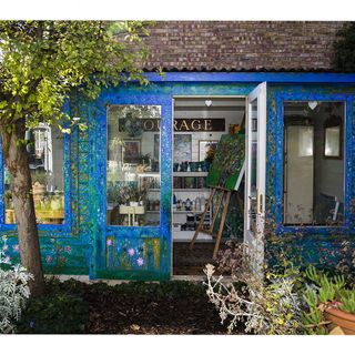 studio shed with blue wall and garden