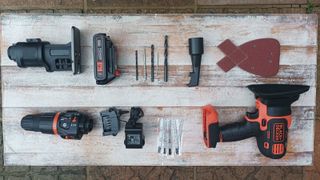 Selection of Black Decker MultiEvo Multi Tool tools laid out on white wooden background