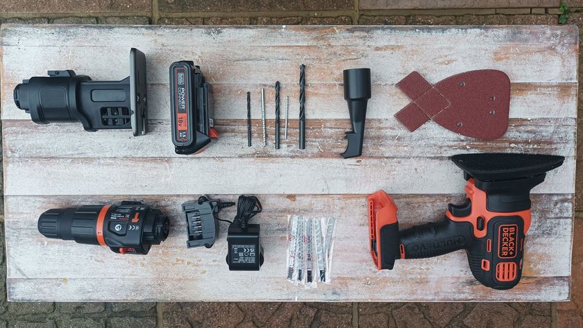 Selection of Black Decker MultiEvo Multi Tool tools laid out on white wooden background