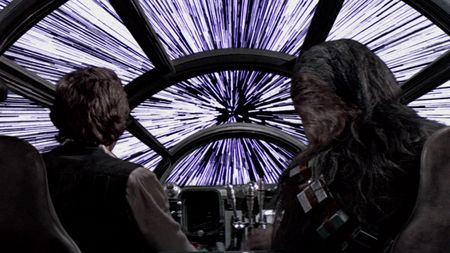 Han and Chewie look out of the cockpit as the Millenium Falcon enters hyperspace.