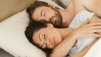 Man holding woman sleeping