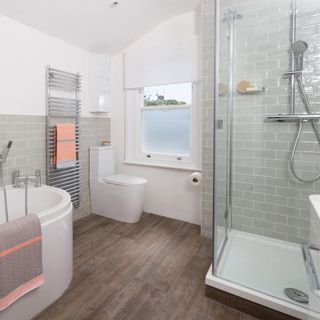 white walled bathroom with bathtub commode and shower