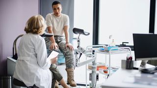 woman in a hospital talking to a gynecologist 