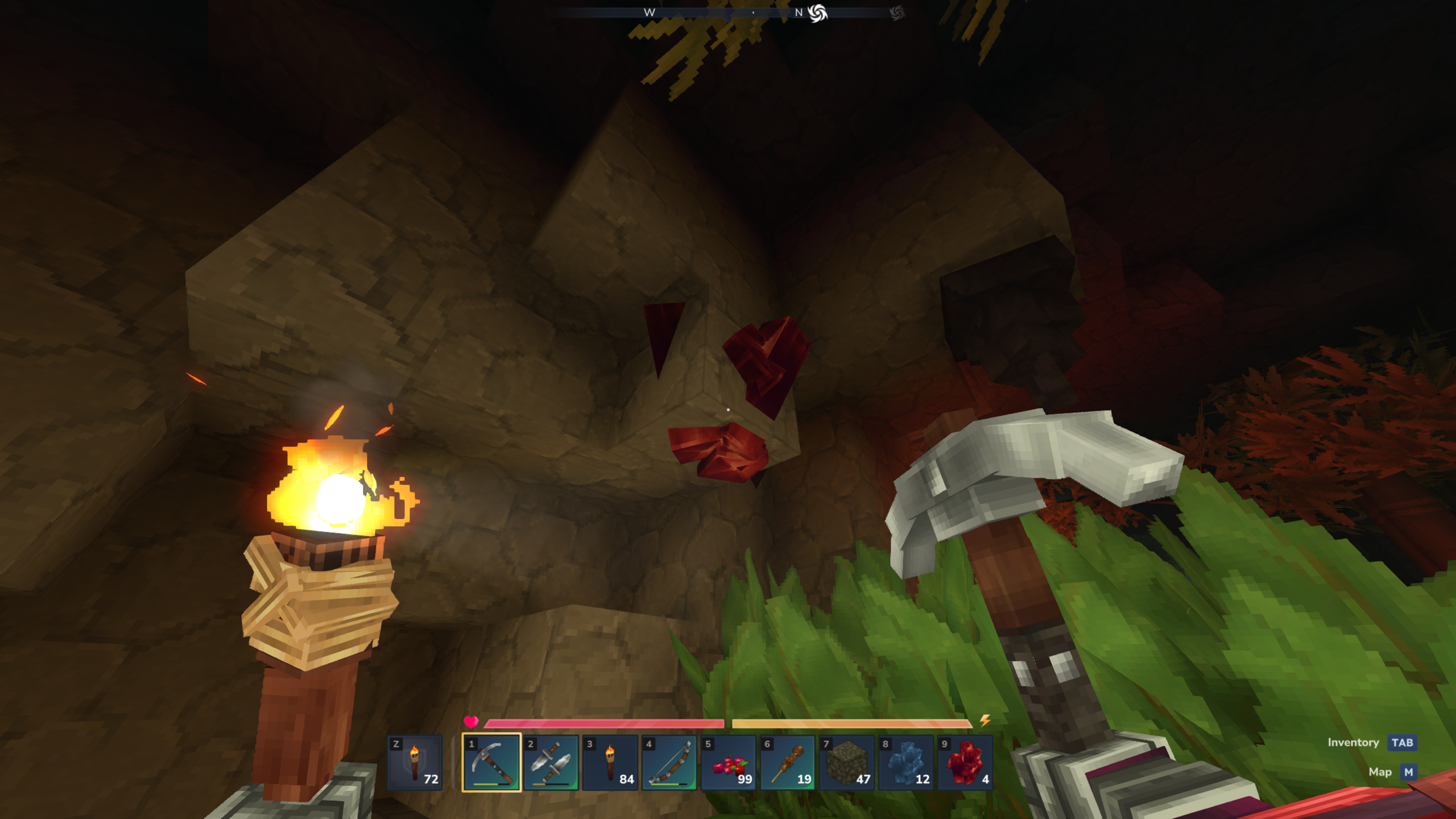 Hytale adamantite: A player holding a torch in their left hand and a pickaxe in their right, looking at a block of adamantite in a cave wall.