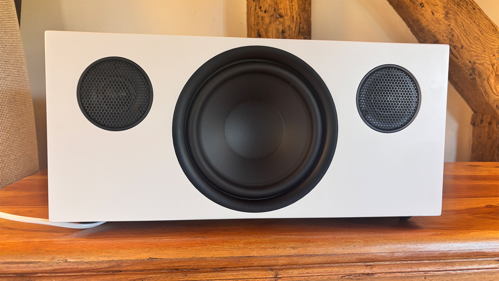 Audio Pro C20 W wireless speaker on wooden shelf