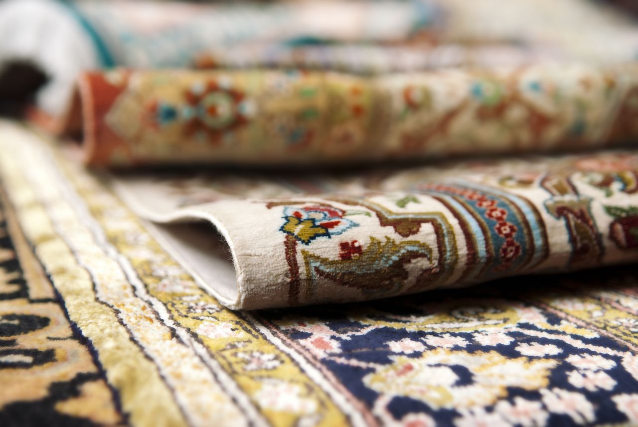 how to clean Oriental rugs: Persian rugs stacked