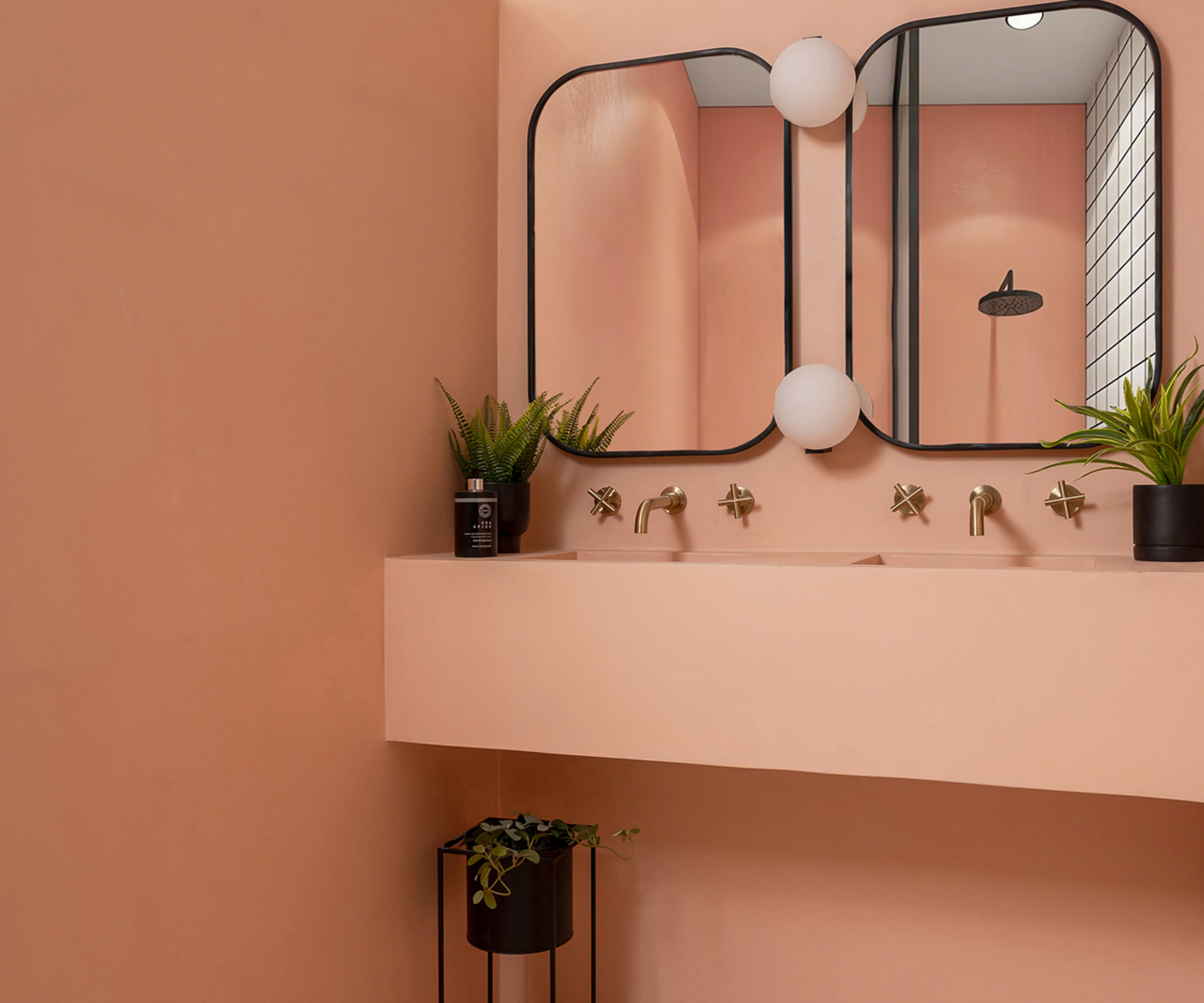 pink microcement bathroom with built in shelving and sinks formed in microcement