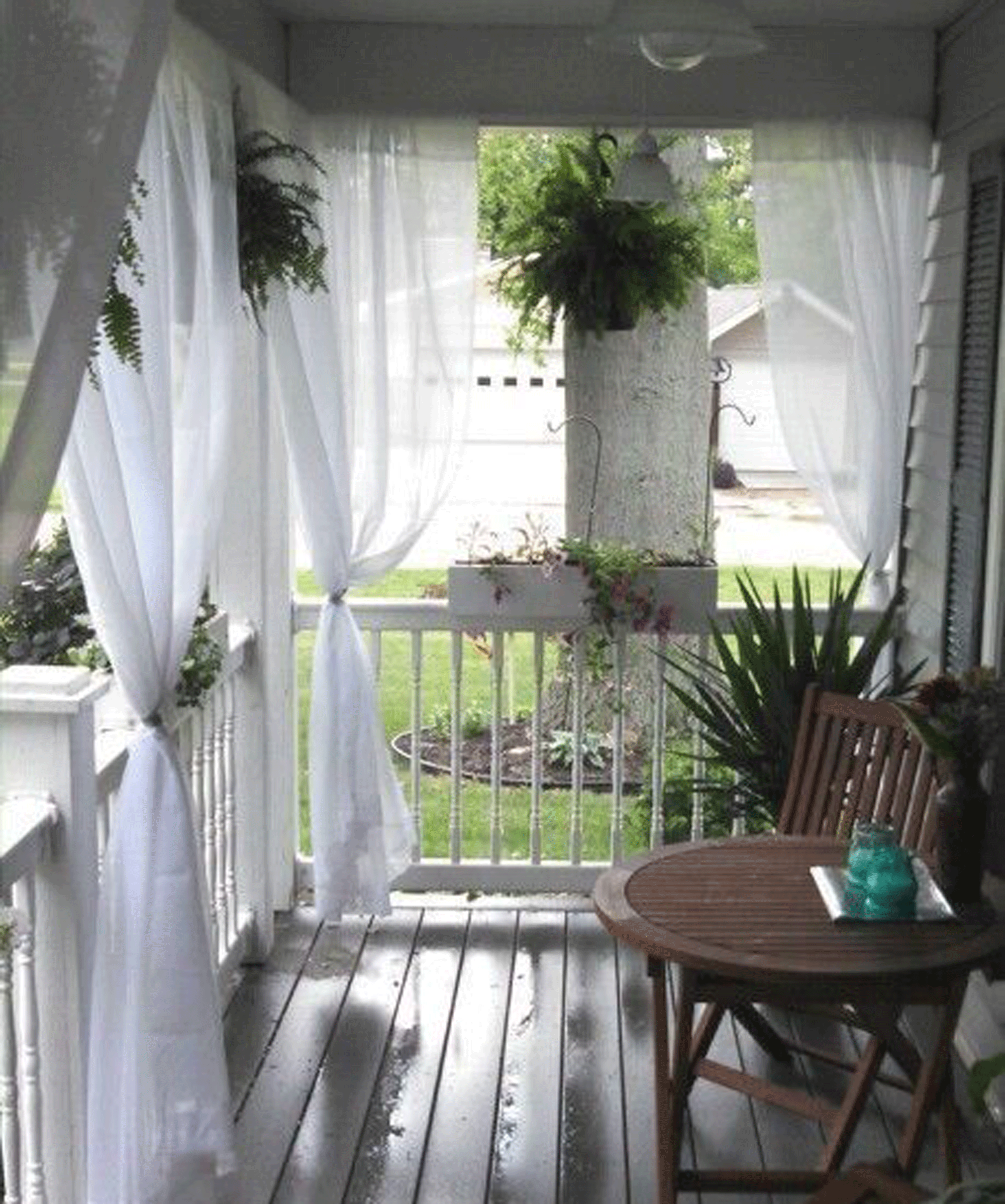 Breezy porch with sheer white panels wafting.