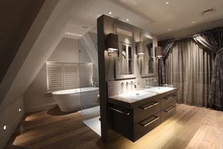 luxury bathroom with partition wall between vanity unit and bath