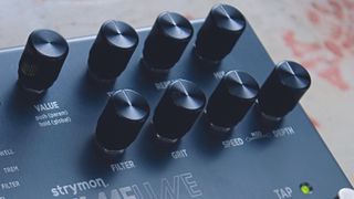 Close up on control knobs on a Strymon TimeLine delay pedal