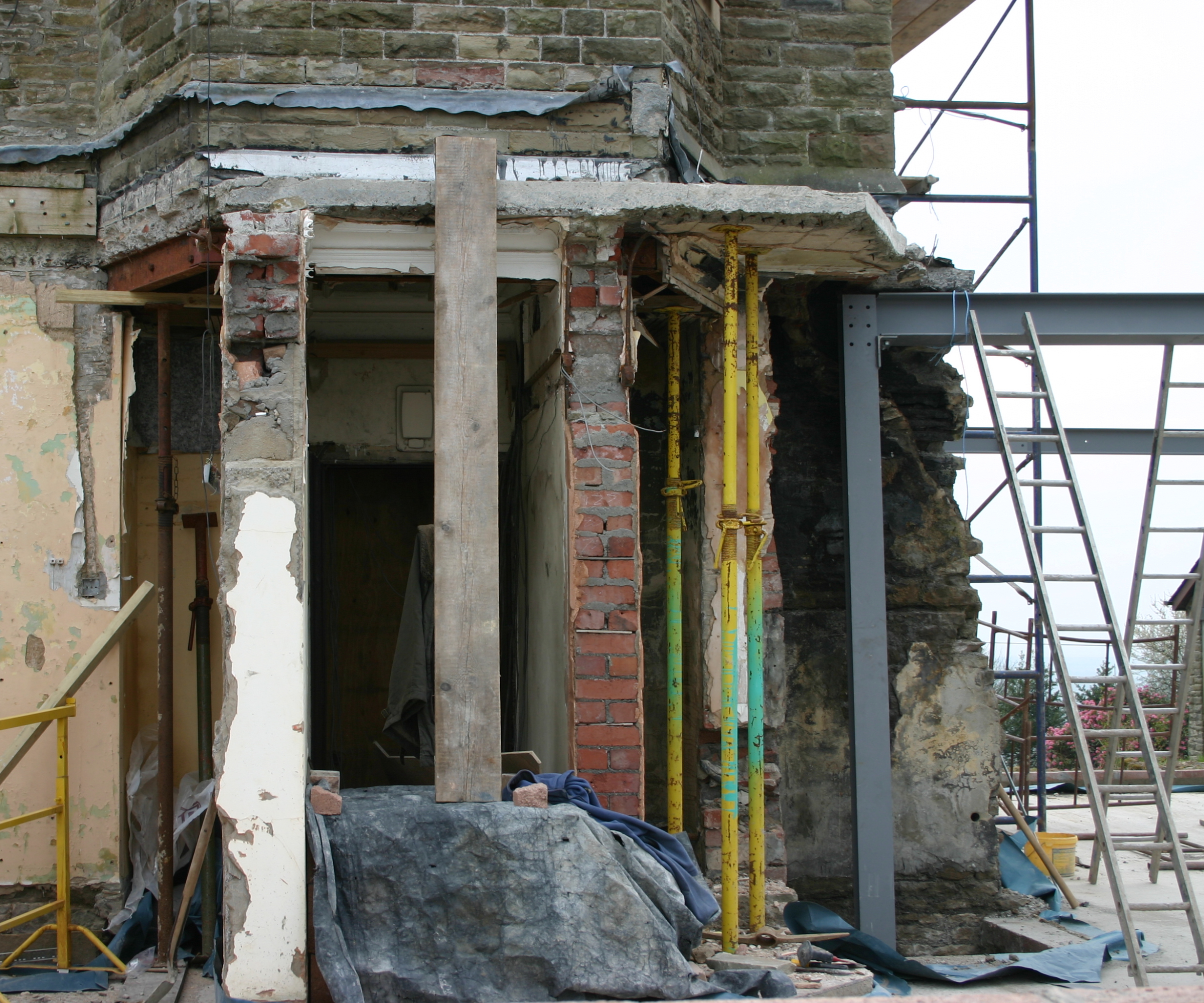 steel frame being joined to old stone and brick building