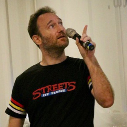 Game developer and Springloaded founder James Barnard speaking into a microphone