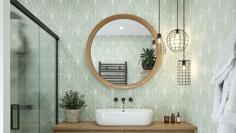 bathroom sink with round wooden mirror and green tiles