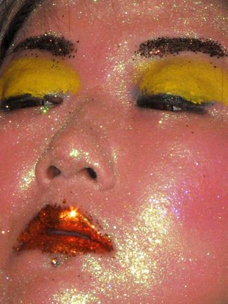 A model with glitter face paint