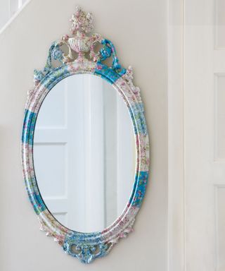 oval shaped mirror on white walls