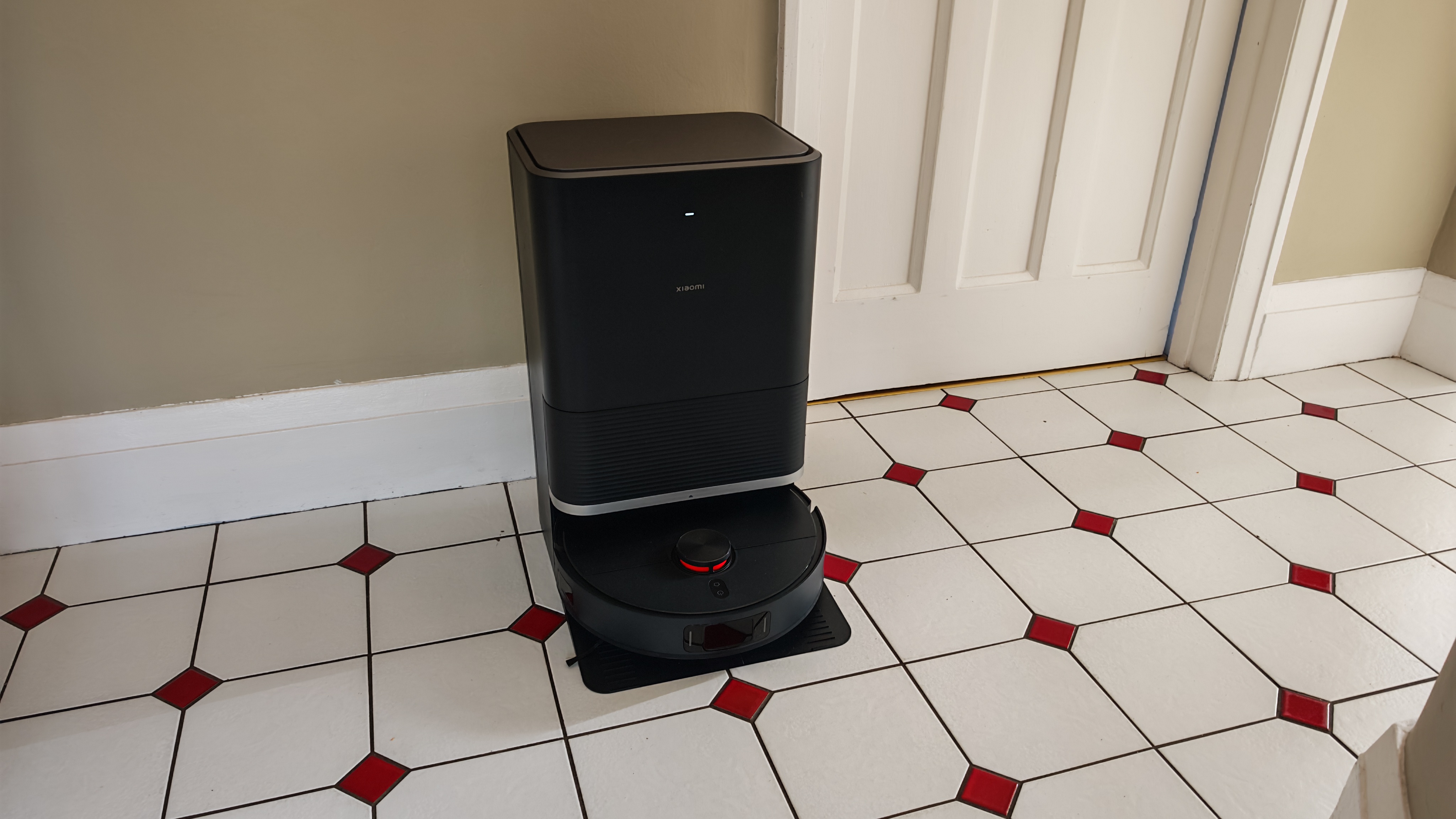The Robot Vacuum X20 Max from Xiaomi in a hallway with a tiled floor.