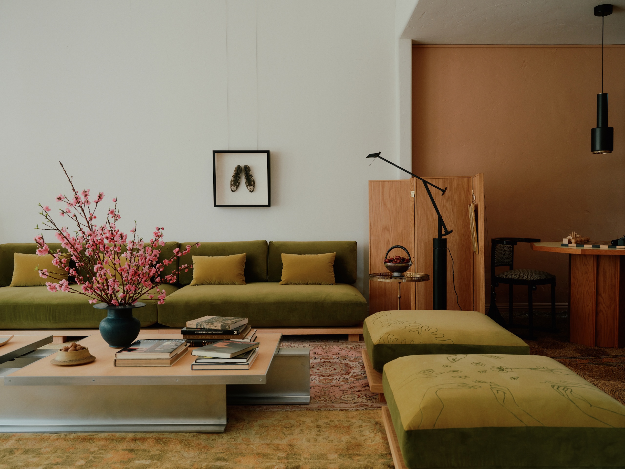 A contemporary living space with a green velvet armless modular sofa
