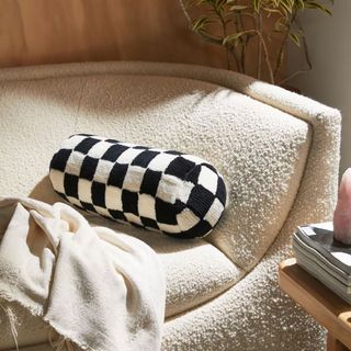 Checkerboard bolster pillow on fleece-lined couch
