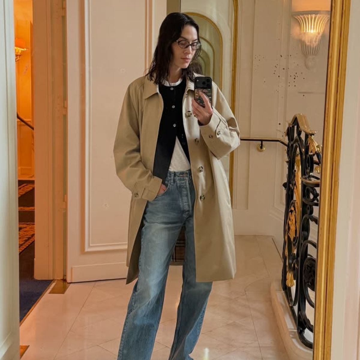 An image of @alexachung wearing blue jeans with brown loafers whilst in Paris. 