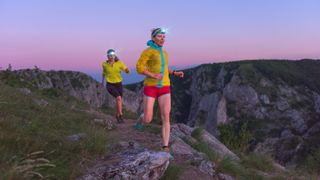 Two trail runners with headlamps