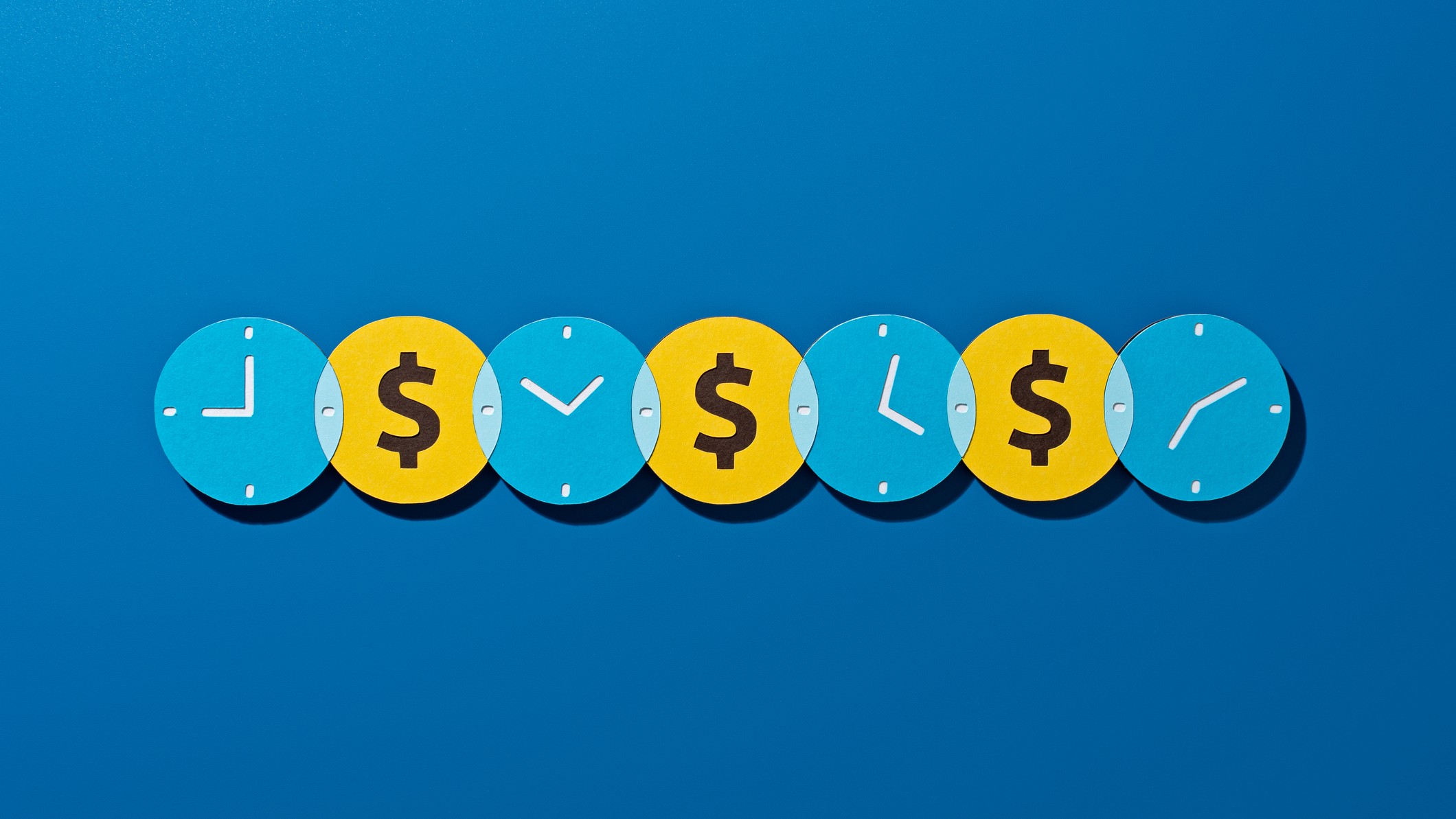 four clock faces at different times with yellow circles with dollar signs in between and a blue background