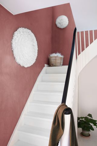 Feather wall lamps from Sweetpea & Willow in a pink hallway